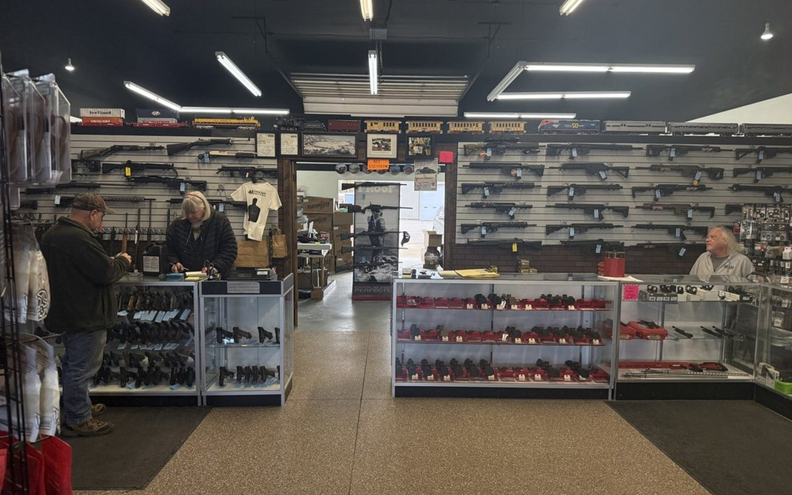 Inside Machine Guns Montana, the gun wall and display cases on the shop floor in Kalispell, Montana